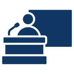 Icon of a person speaking at a podium with a microphone and a large rectangular screen or board behind them.