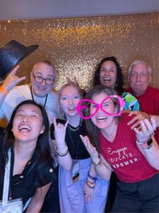 A group of people posing for a picture in a photo booth.