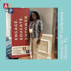A woman standing next to an event banner.