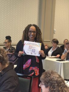 A woman holding up a sign in front of other people.