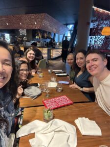 A group of people sitting at a table with drinks.