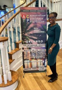 A woman standing next to a sign on the stairs.