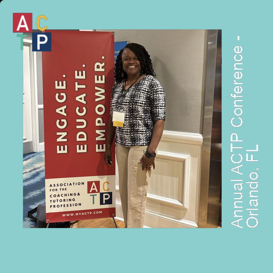 A woman standing next to an event banner.