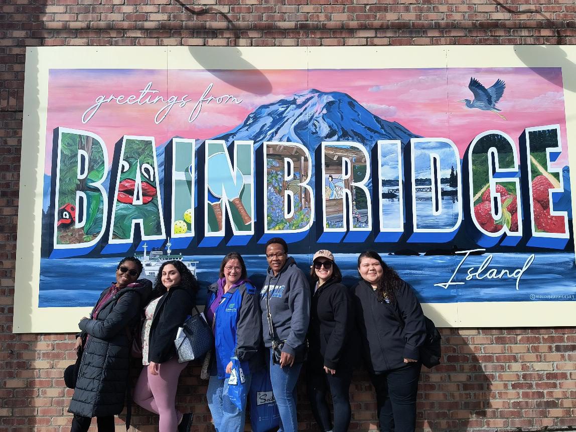 Group by Bainbridge Island mural sign.
