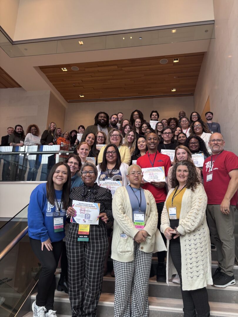 Group photo of people on staircase.