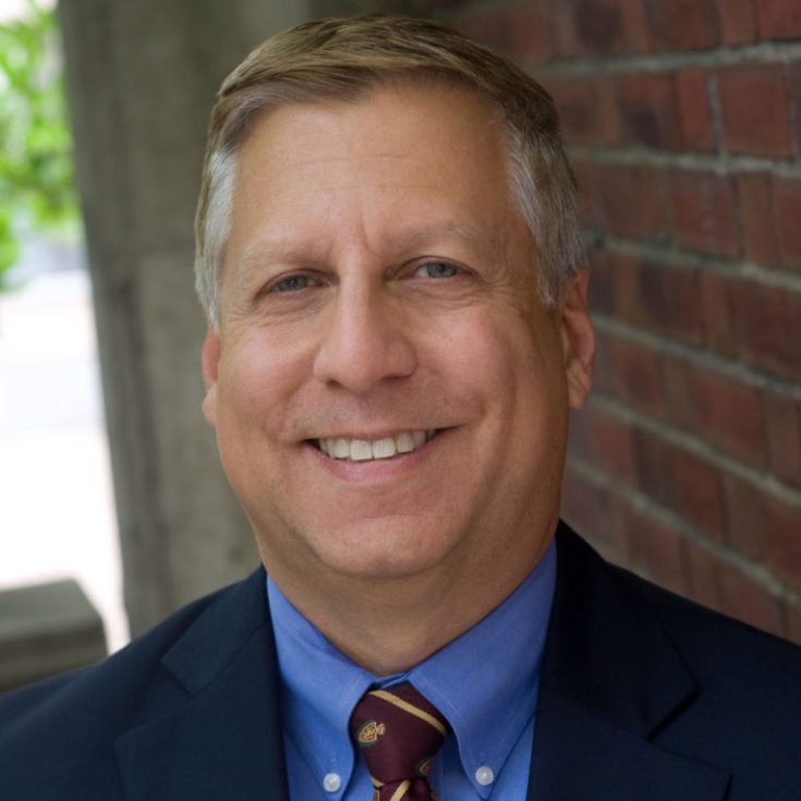 Jack-Truschel_2018_edited-1-800x766-768x735 A man in a suit and tie smiling for the camera.